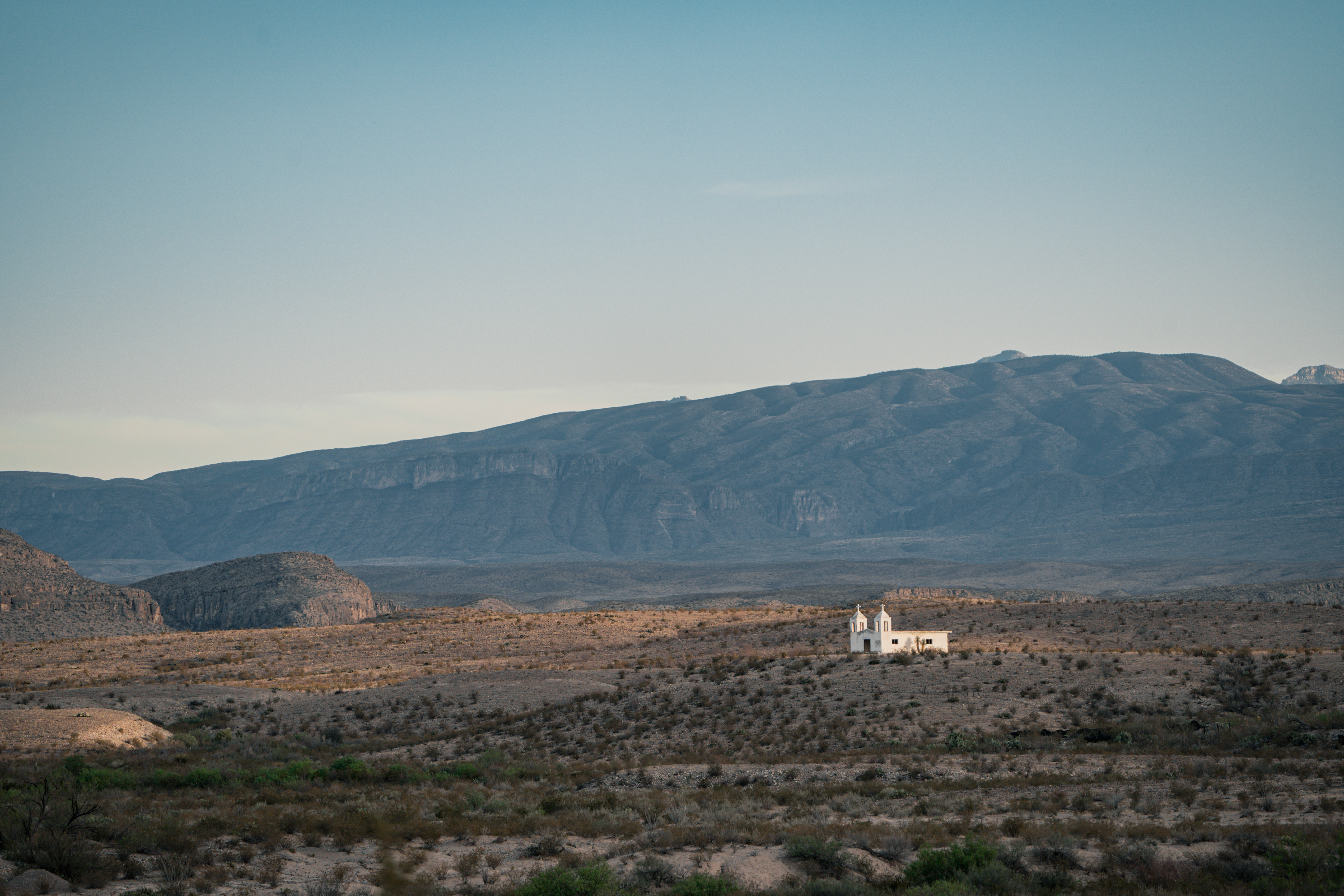 Desert church with mountain landscape